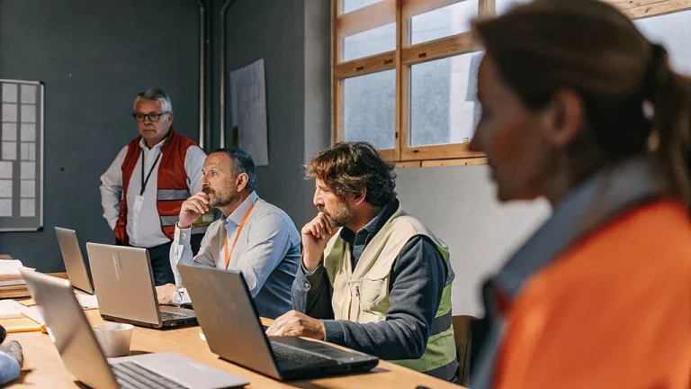 Professionals coordinating a crisis response in a business continuity operations room