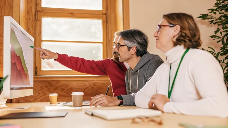 Team reviewing generative AI evaluation results on a monitor in an office